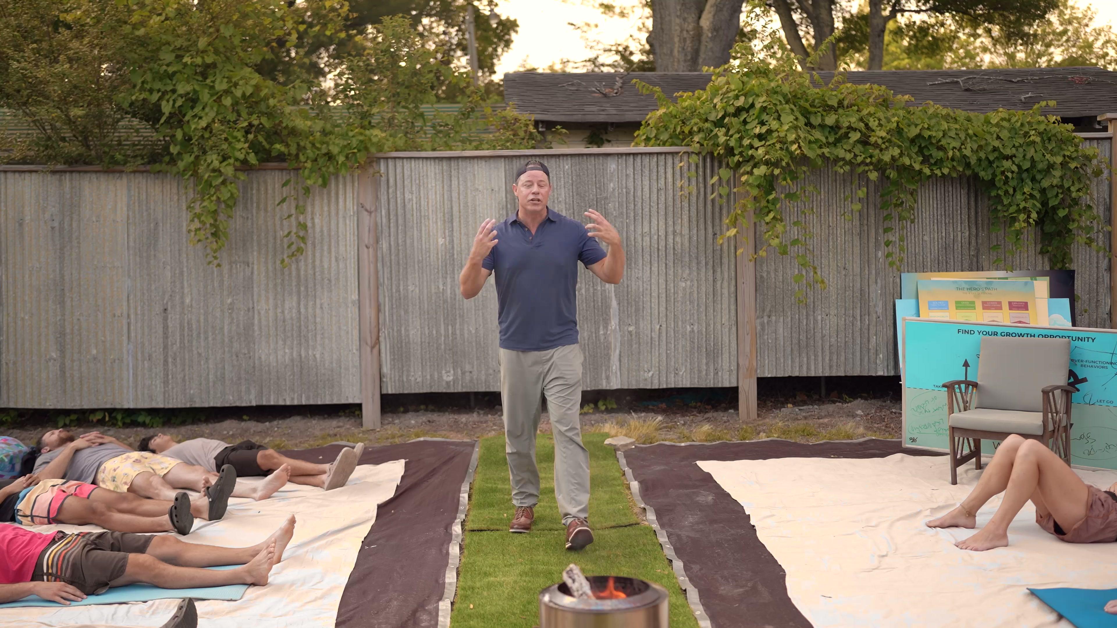 Bill Wilder leading breathwork with a group lying on mats outdoors
