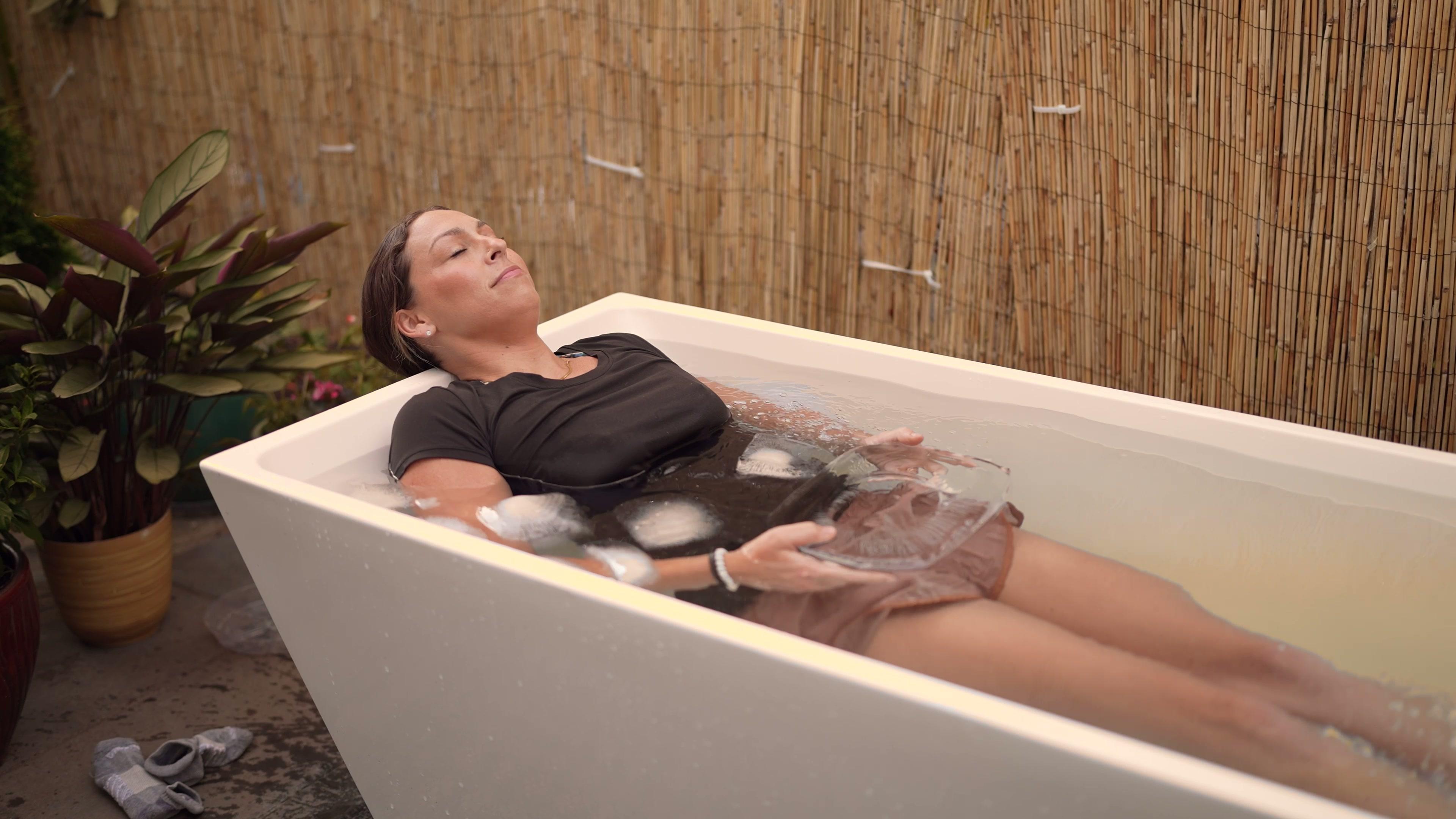 A participant lying calm in the cold plunge tub