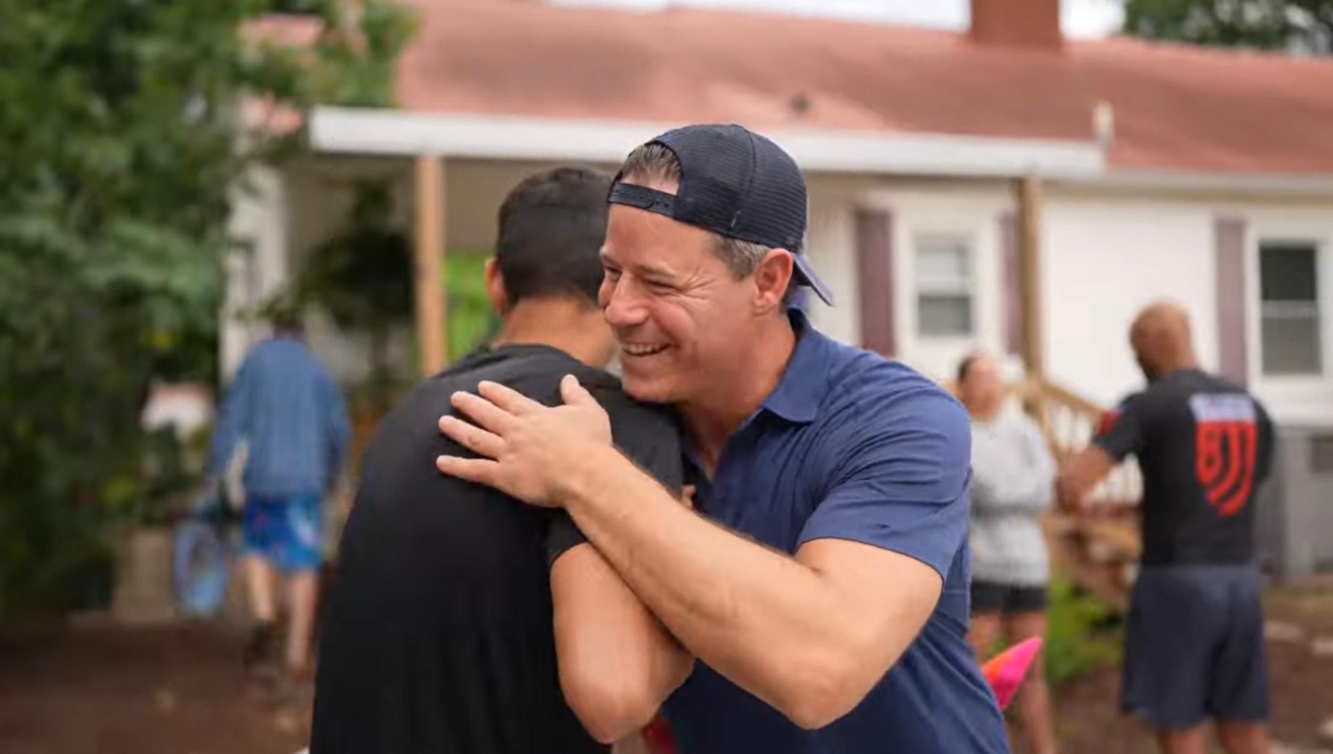 Bill Wilder embracing a participant after an outdoor group experience