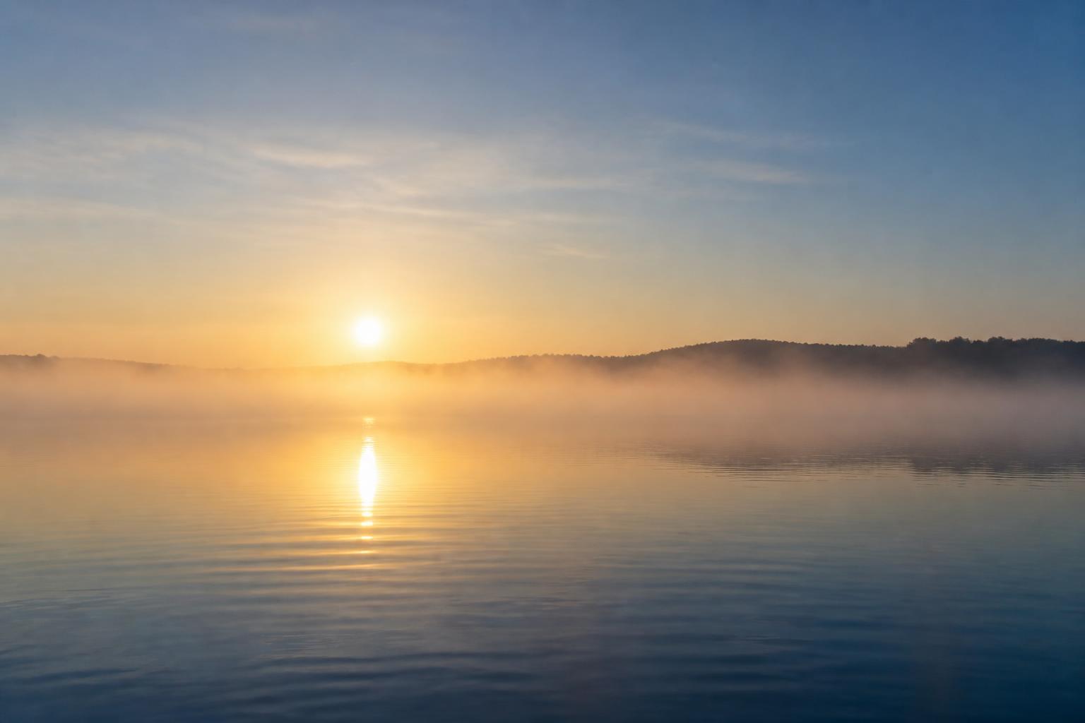 Calm lake water at sunrise
